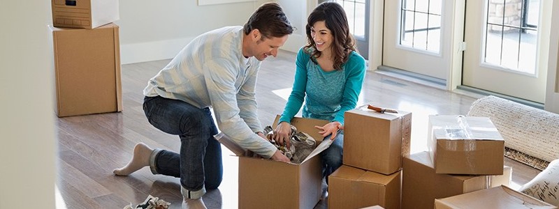 young couple packing their household for relocation