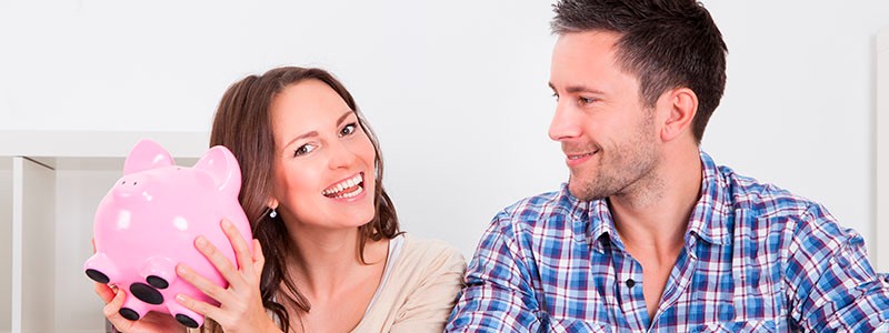 young couple with a piggy bank