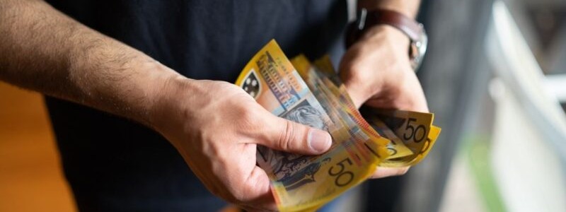 cropped picture of a person counting currency