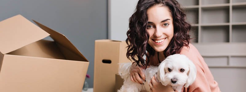 young woman preparing for a household relocation with pet