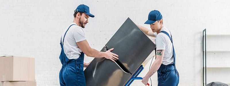professionals preparing a refrigerator for relocation