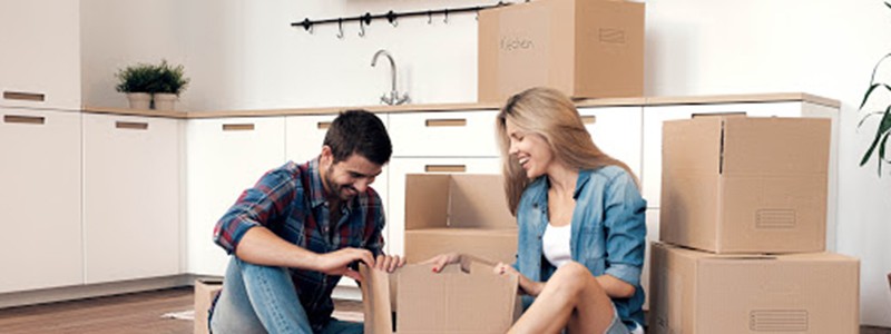 young couple packing up a kitchen items