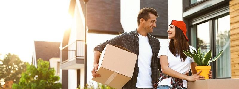 young couple with cardboard boxes preparing for household relocation
