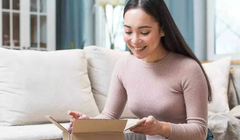 woman preparing for a move and packing a box